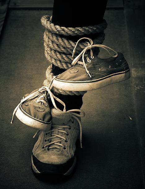 Dirty sneakers hanging on a clothesline