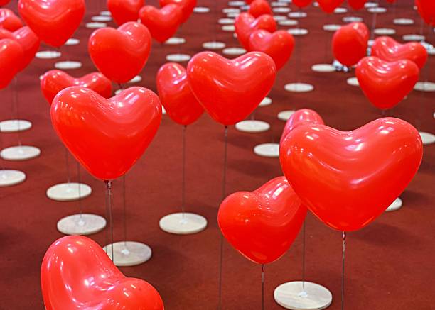 Red heart shape balloons on floor as props for Valentine's festival background