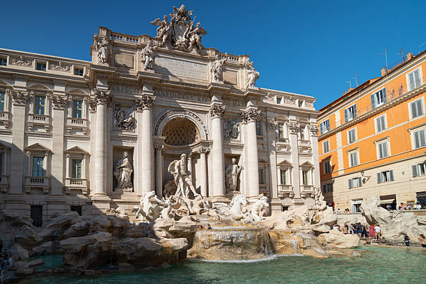 Rome, Italy - September 26, 2023:Tourists gather, admiring the baroque architecture and sculptures of the historic trevi fountain in rome, a popular landmark drawing a large group of people