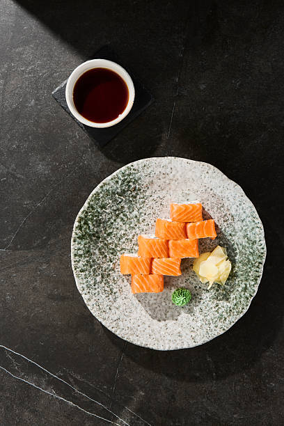 Philadelphia roll with salmon and cream cheese, bright lighting, overhead composition