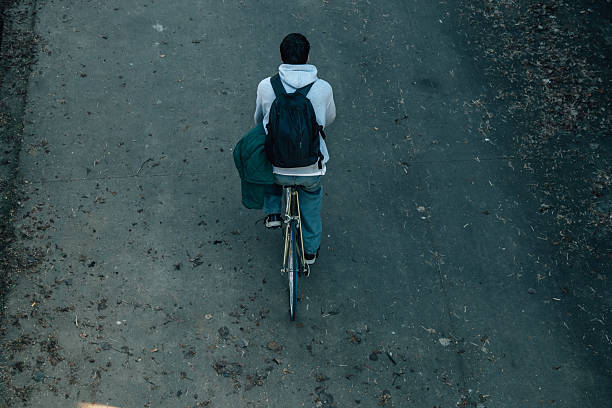 top view of a young man riding a bicycle