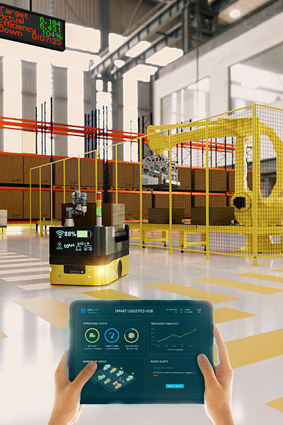 Smart warehouse automation worker controlling AGV robot using tablet with AR dashboard interface in futuristic logistics center.