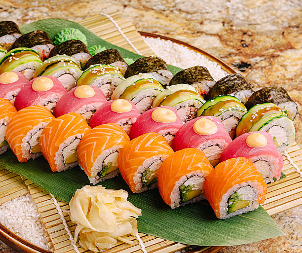 Sushi platter featuring assorted rolls presented on a decorative tray