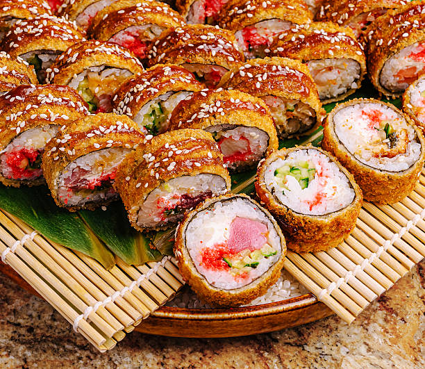Delicious sushi rolls arranged beautifully on a wooden platter
