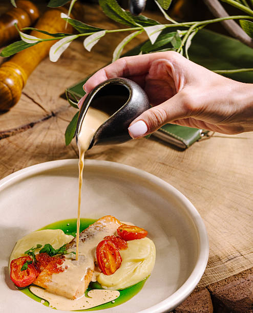 Delicious salmon dish with sauce served on wooden table