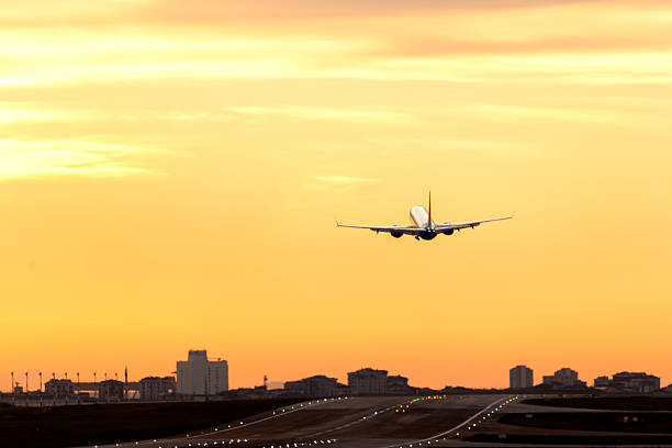 Passenger airplane taking off on sunset