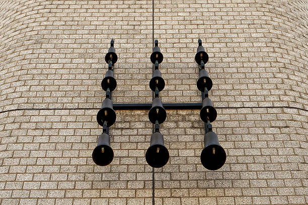 An ancient bronze bell on a white wall background.Selective focus.