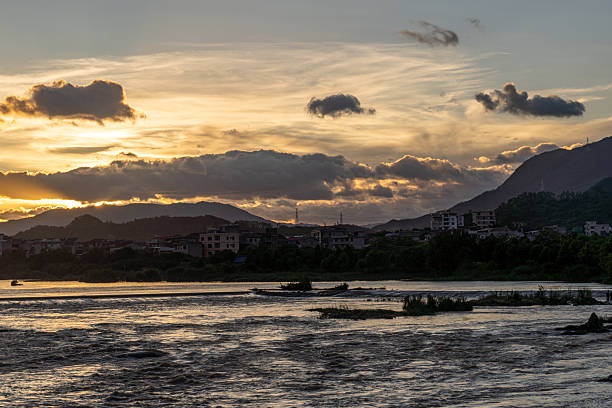 The turbulent and murky stream at dusk