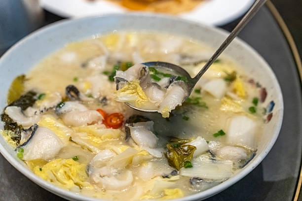 Chinese dish pickled Chinese cabbage fish soup with a tablespoon with one hand