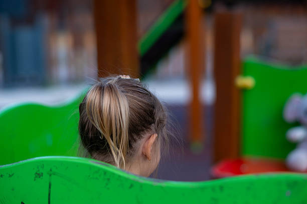 Young girl playing on a colorful playground, enjoying leisure time during childhood