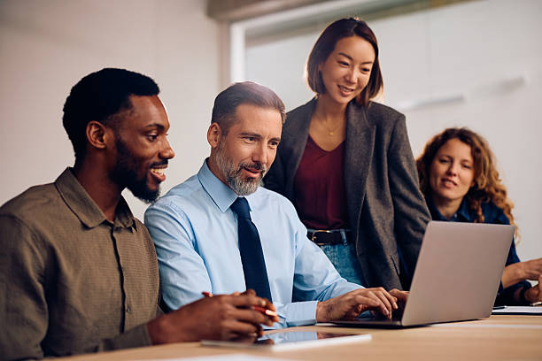 istock Multiracial business team cooperating while working on laptop in the office. 2257415415
