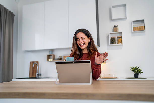 istock Woman having video call on tablet in kitchen 2257418315