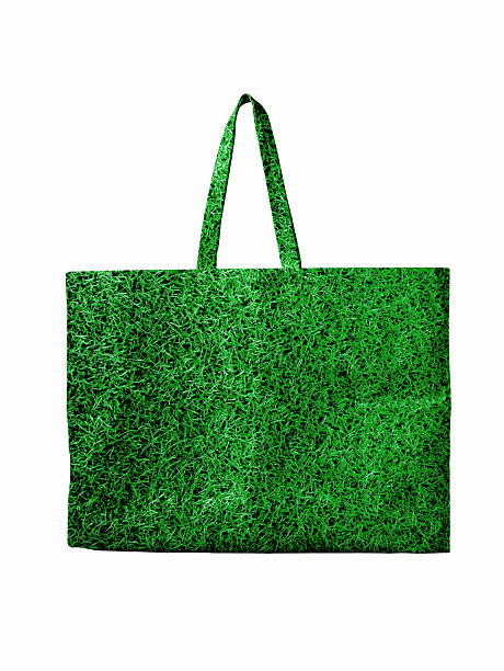 Green grass texture tote bag isolated on white background, symbolizing eco friendly lifestyle, sustainability, green marketing and environmental responsibility. Ideal for advertising, branding, reusable shopping bag concepts and environmental campaigns.