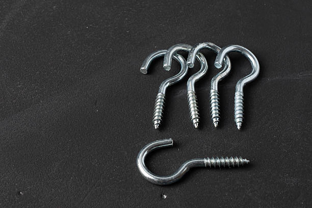 Set of metal screw hooks and eye bolts displayed on a black background. Perfect for industrial catalogs, hardware identification, and engineering product imagery.