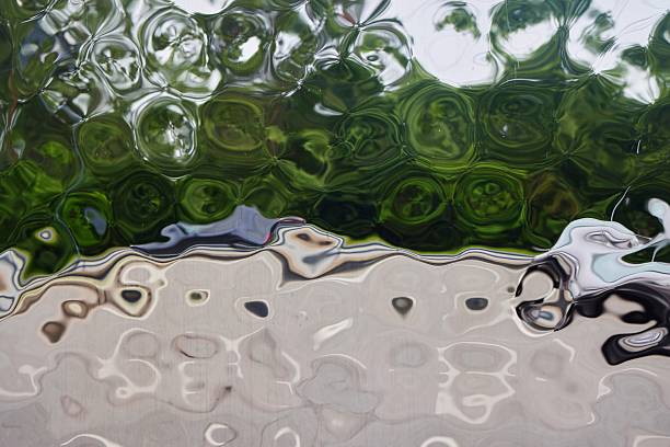 The texture of the dented metal is silver in color with a glossy surface