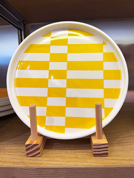 Image of yellow and white plate crockery with modern colourful design, contemporary tableware, minimalist dining, stylish kitchenware