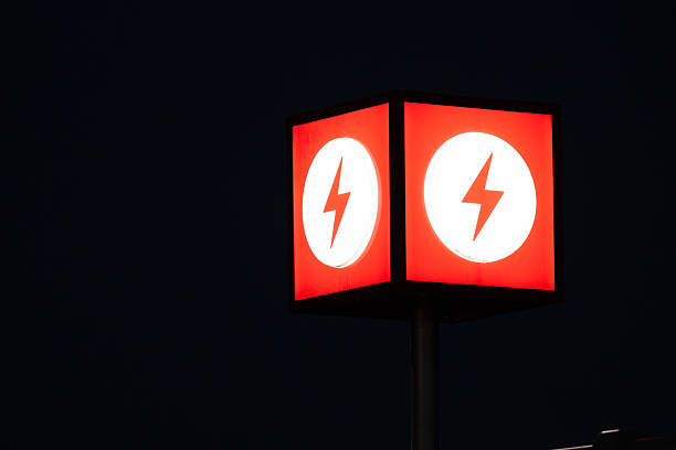 Red electric power symbol light against dark background