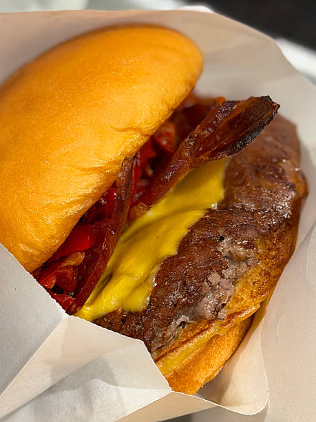Image of cheeseburger beef burger hamburger with melted cheese and crispy bacon in bread roll fast food