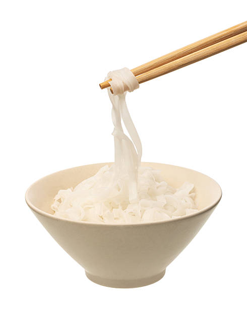 Plate with rice noodles and chopsticks isolated on white background