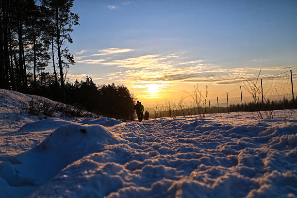 Gdansk, Poland - January 06, 2026: Snowy Path at Golden Hour with runners