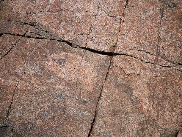 Red natural pattern, texture of cracked granite stone on background, full frame