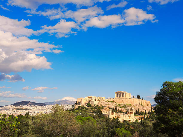 Ancient Acropolis citadel with Parthenon temple on hilltop in Athens Greece under blue sky