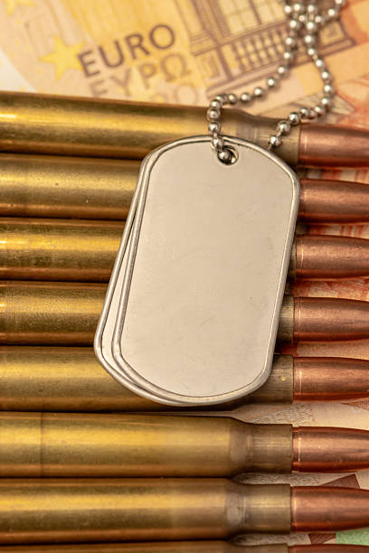 Soldier identification tags on ammunition and euro currency background
