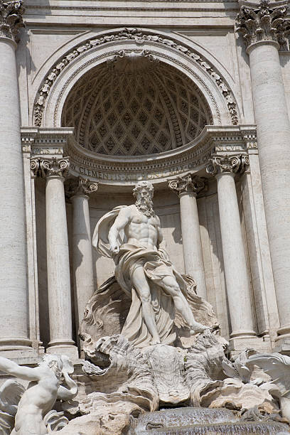 Trevi Fountain (Fontana di Trevi) in Rome in warm morning light on a sunny morning in spring (late April). The fountain was designed by architect Nicola Salvi and was completed in 1762. It is the largest Baroque fountain in Rome standing 26 meters high and 49 meters wide. It is one of the most famous and popular landmarks of Rome. It is common to stand in front the fountain (with the back towards the fountain) and toss a coin over the left shoulder into the water as a sign of returning to Rome another time. The coins are collected regularly and used for charity.