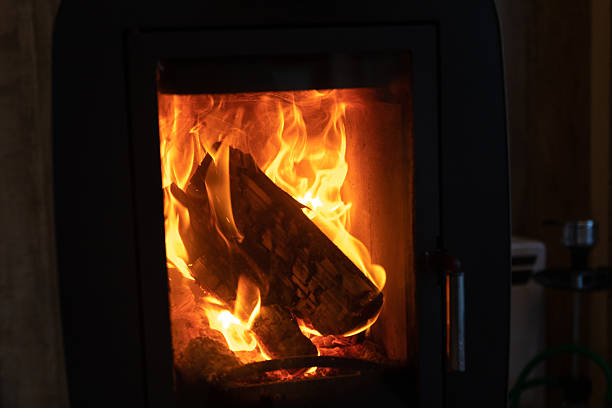 a burning stove with firewood