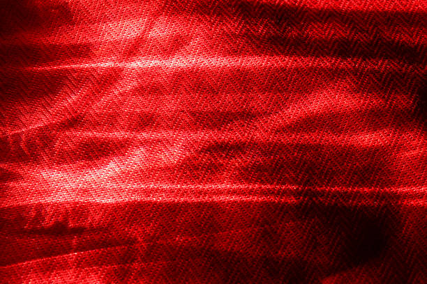 Seamless texture of embroidered fabric with red threads. Geometric tessellated surface. Seamless repeating pattern.