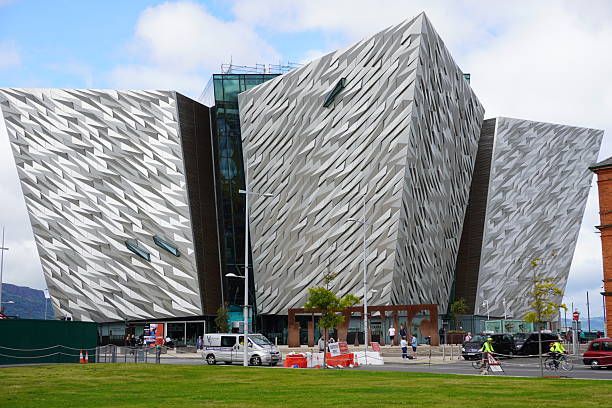 The striking contemporary architecture of the Titanic Belfast monument and museum, featuring its distinctive aluminum-clad hull-shaped wings, located in the Titanic Quarter, Belfast, Northern Ireland.