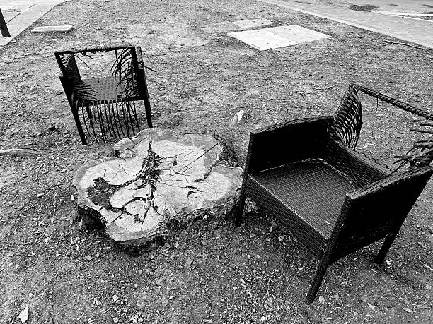 Two broken garden chairs on sidewalk. Berkeley Hills, California.