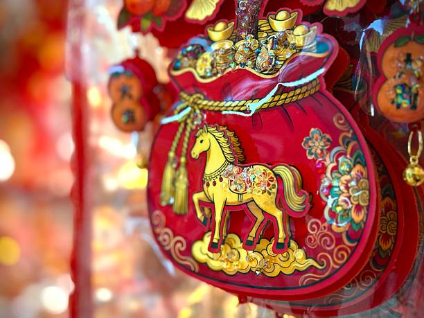 Close-up of Chinese New Year hanging and ornament decorations for sale during horse zodiac or horoscope Lunar New Year 2026