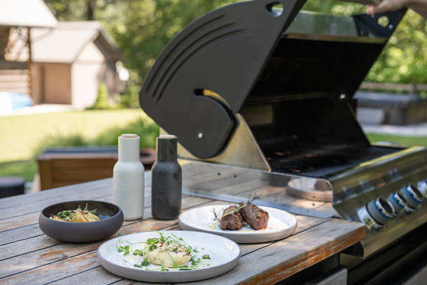Grilled steak and cauliflower beside barbecue in backyard