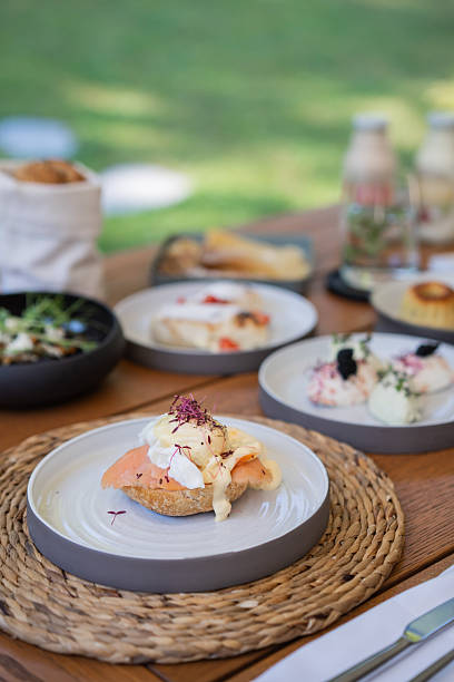 Eggs Benedict with smoked salmon and hollandaise sauce in outdoor garden