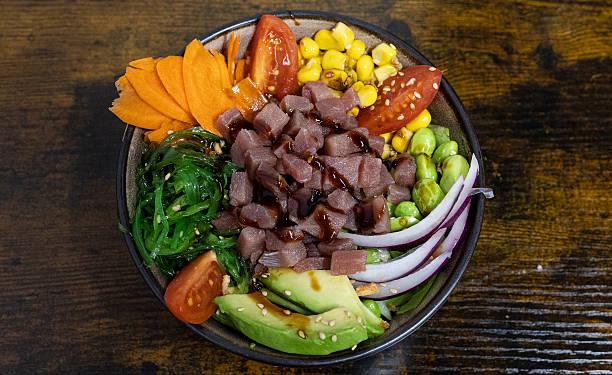 Fresh poke bowl with tuna, avocado, vegetables, and sesame seeds
