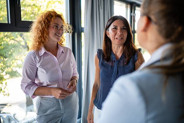 istock Businesswomen having casual conversation in modern office space 2257531200