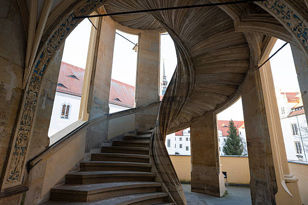 An indoor spiral staircase with a view from below