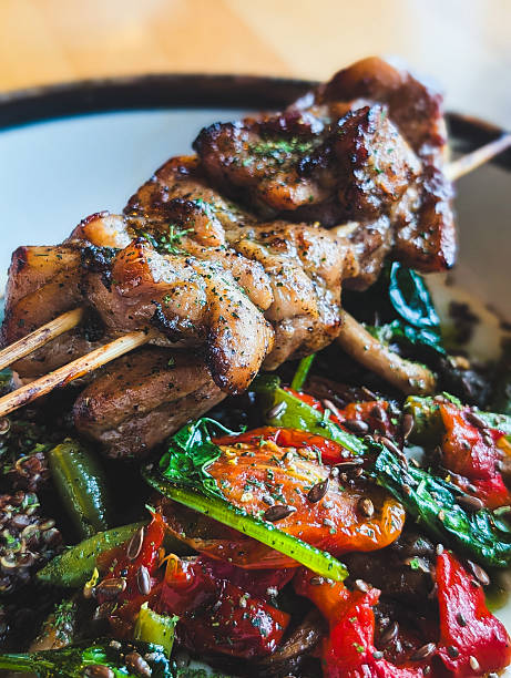 Grilled chicken skewers with roasted vegetables and quinoa