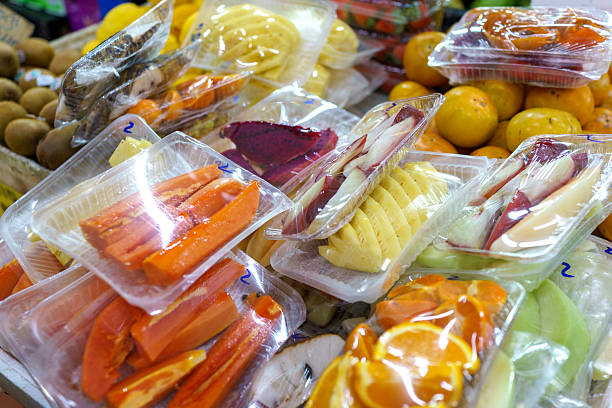 Freshly Cut Tropical Fruits Packaged for Sale at Local Market Stall