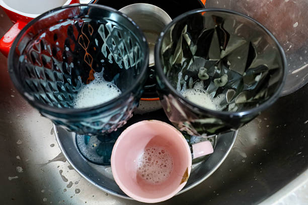 Woman preparing a cup of tea in a domestic kitchen in a modern Japanese home