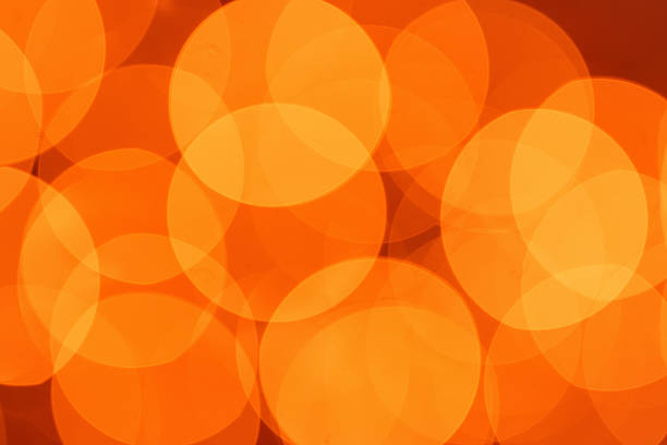 Bright orange circles fill the space, creating a warm and vibrant atmosphere. This scene captures the energy and excitement of a lively evening gathering.