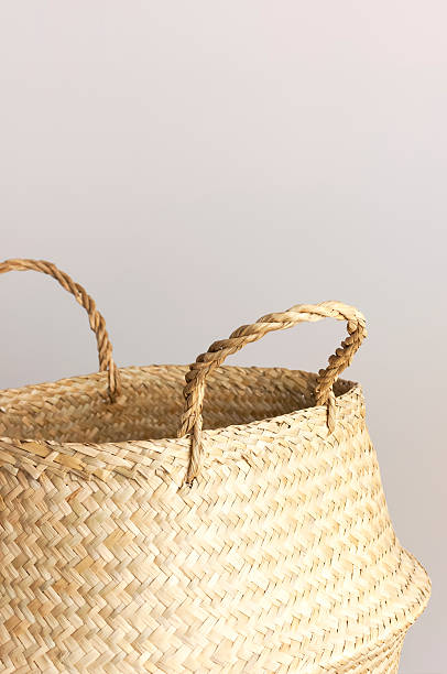 istock Empty straw wicker basket on a gray background. Fashionable bamboo basket, stylish interior item, eco design, handmade. Natural decor of the interior, home. Natural eco materials, storage basket 2257572534