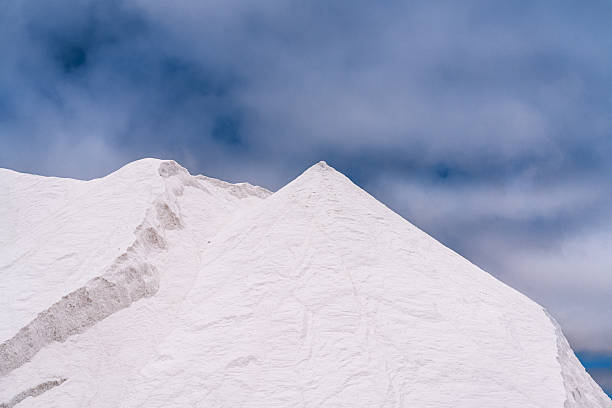 Salt works at Walvis Bay on Namibia’s Atlantic west coast near Swakopmund. Vast piles of raw salt await export and further processing. Namibia, Africa.