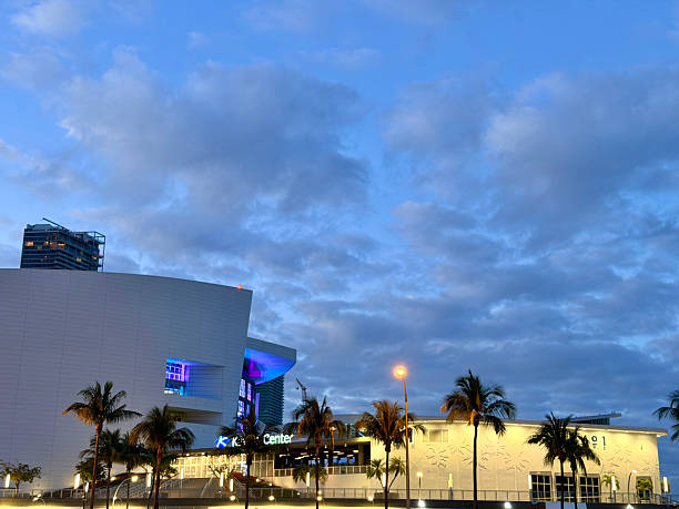 Miami, Florida, United States of America - January 10, 2026: Kaseya Center buildings illuminated at dusk, showcasing modern architecture and palm trees under a cloudy blue sky in Miami, Florida