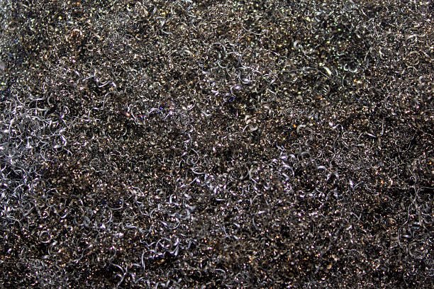 Macro photograph of steel wool, creating an abstract and textured background. The image showcases intricate patterns and reflections, highlighting the details of the metallic material. Perfect for use in industrial or creative design projects.