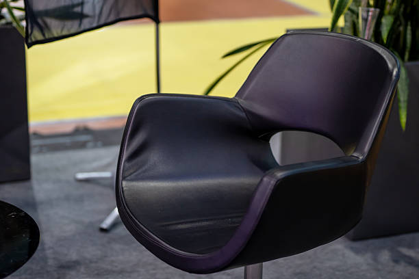istock A sleek black chair that features a striking purple stripe on its arm rest 2257590527