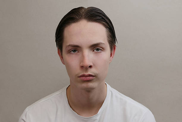 Portrait, vision and closeup with a handsome man looking serious or thoughtful against a blurred background. Face, focus and mindset with the eyes of a male person feeling confident or optimistic