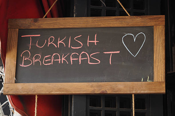 A chalkboard sign displays Turkish breakfast special in a cozy cafe.