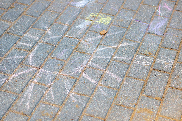 Happy little toddler girl in animal painted with colorful chalks on ground or asphalt in summer. Cute child having fun. creative leisure